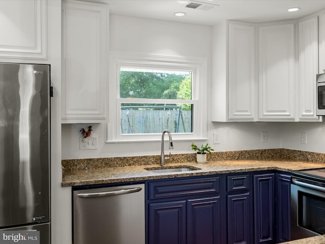1904 N Amelia St, Sterling, VA 20164 - kitchen with stainless steel appliances, a sink, blue cabinets, and white cabinets