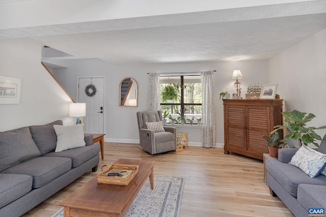 living room featuring baseboards and light wood-style flooring