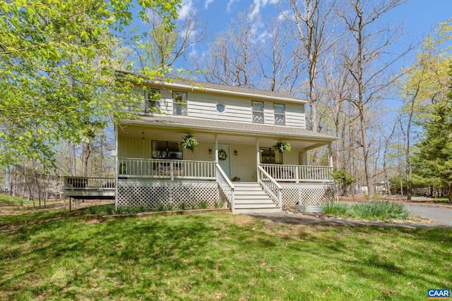 view of front of property featuring a porch, stairs, and a front yard