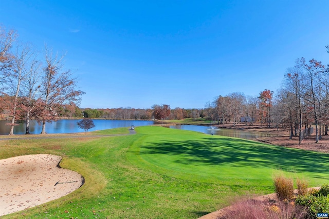 view of community featuring a water view, golf course view, and a yard