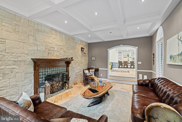 living room with recessed lighting, arched walkways, and beam ceiling