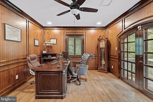 office with ornamental molding, a ceiling fan, french doors, and light wood-style flooring