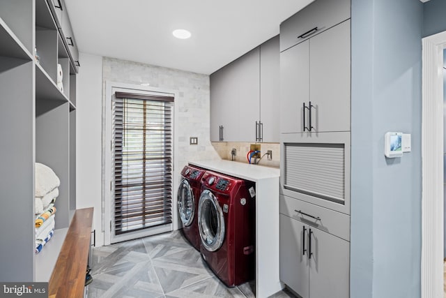 laundry room with cabinet space and washing machine and clothes dryer