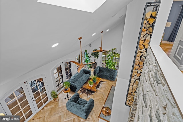 living area with french doors, recessed lighting, and lofted ceiling with skylight