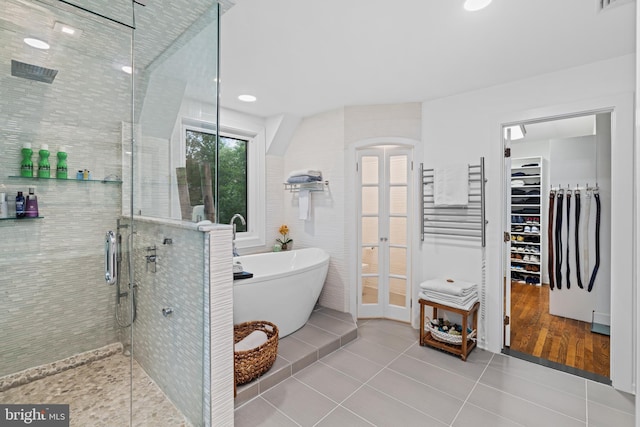 bathroom with visible vents, a freestanding tub, tile patterned floors, a shower stall, and french doors