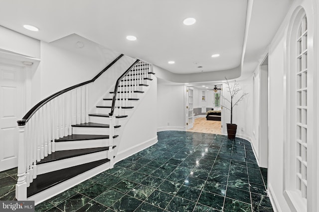foyer entrance with recessed lighting, baseboards, a ceiling fan, and stairs