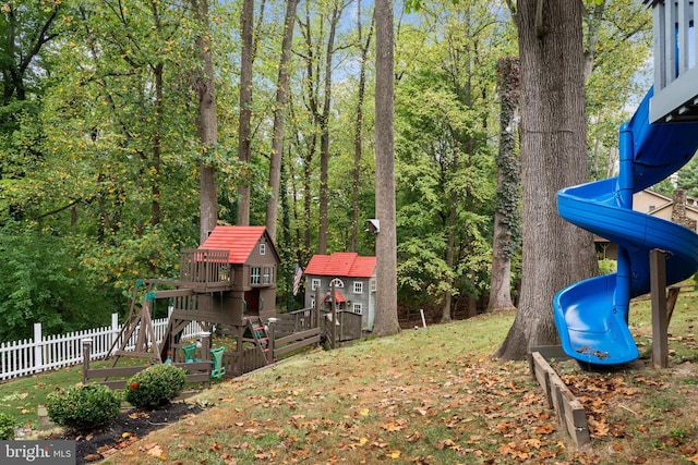 view of yard with a playground and fence