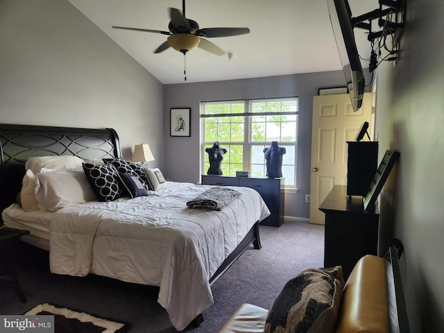 carpeted bedroom with baseboards, a ceiling fan, and vaulted ceiling