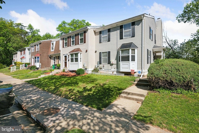 view of front of property with a chimney and a front lawn