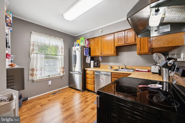 kitchen featuring a sink, extractor fan, stainless steel appliances, visible vents, and light countertops