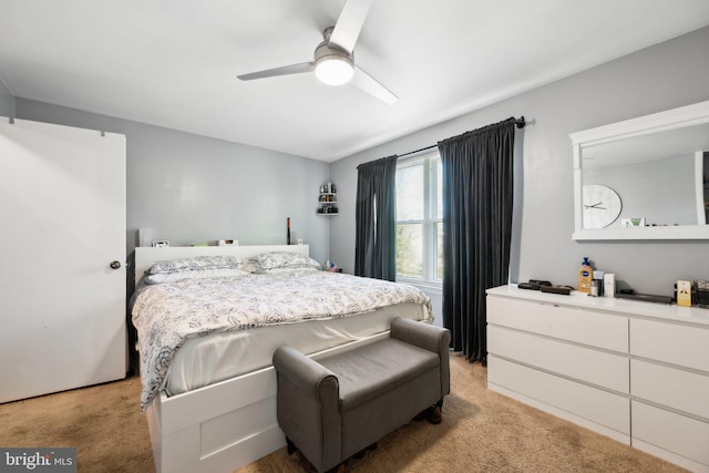 bedroom featuring a ceiling fan and light carpet