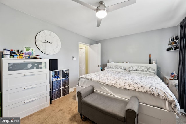 bedroom featuring light carpet and a ceiling fan