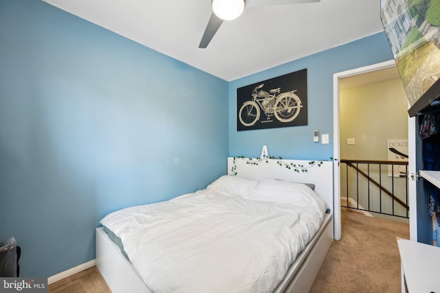 carpeted bedroom featuring baseboards and ceiling fan