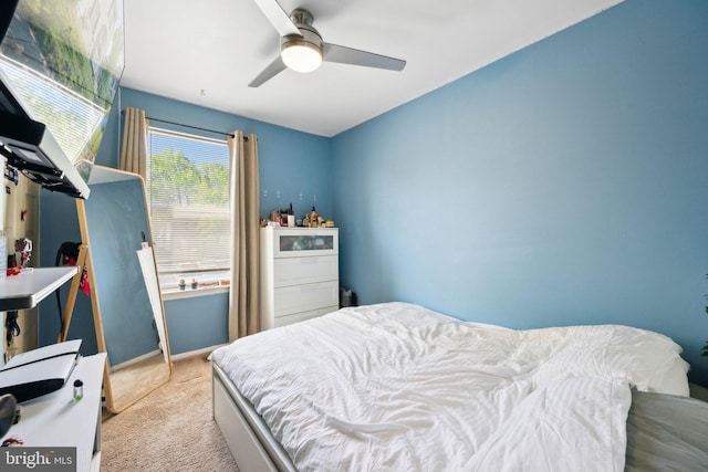carpeted bedroom with baseboards and a ceiling fan