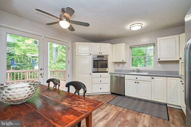 6368 Waterway Dr, Falls Church, VA 22044 - kitchen with stainless steel appliances, a sink, ceiling fan, white cabinetry, and light wood-type flooring