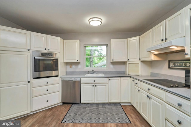 6368 Waterway Dr, Falls Church, VA 22044 - kitchen with appliances with stainless steel finishes, under cabinet range hood, a sink, dark wood-style floors, and white cabinets