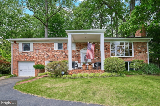 6368 Waterway Dr, Falls Church, VA 22044 - view of front of house with a garage, asphalt driveway, a front lawn, and a porch