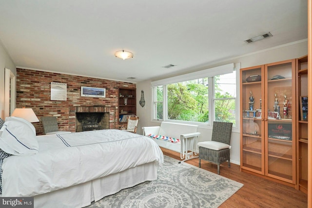 6368 Waterway Dr, Falls Church, VA 22044 - bedroom with wood finished floors, a brick fireplace, and brick wall