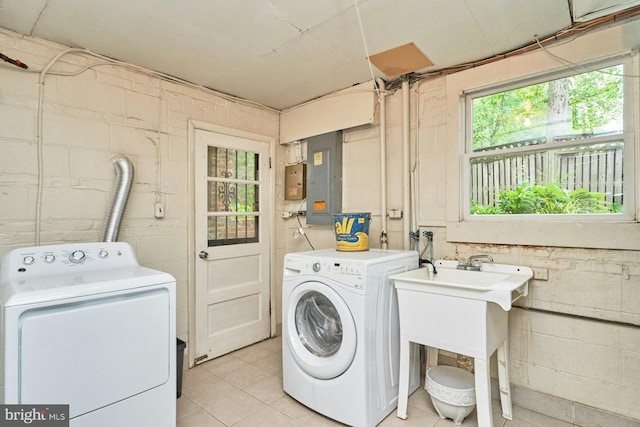 6368 Waterway Dr, Falls Church, VA 22044 - laundry room featuring washing machine and dryer, concrete block wall, light tile patterned flooring, and electric panel