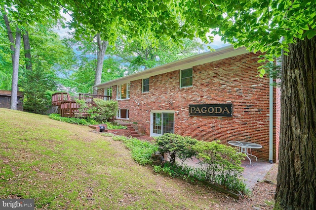 6368 Waterway Dr, Falls Church, VA 22044 - back of house with a wooden deck, brick siding, a lawn, and a patio area