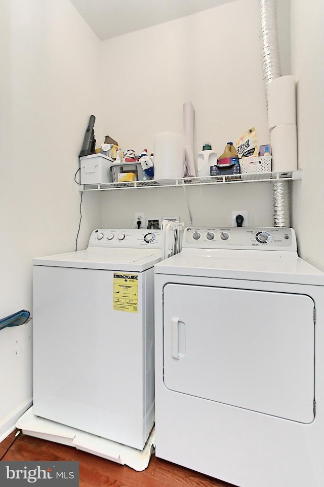 laundry area featuring laundry area, wood finished floors, and washer and clothes dryer