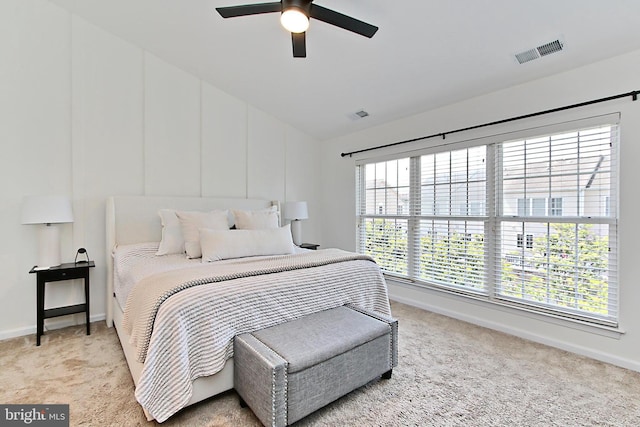 bedroom featuring baseboards, visible vents, light carpet, and lofted ceiling