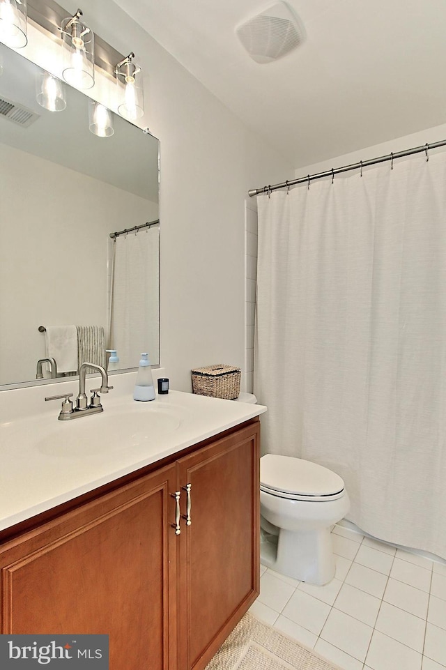 full bathroom with vanity, tile patterned flooring, toilet, and visible vents