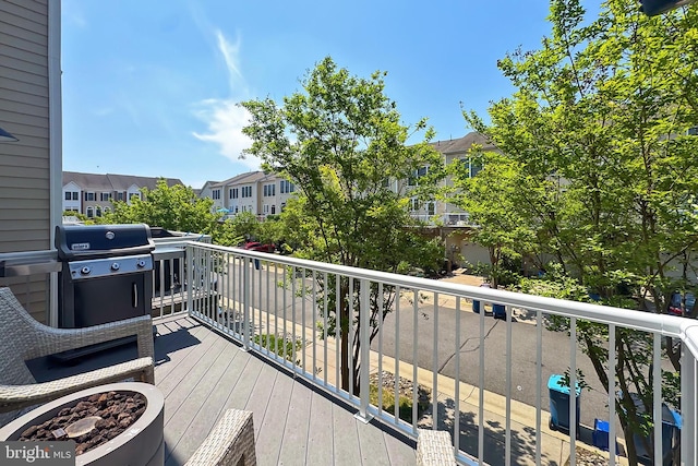 deck with a residential view and a grill
