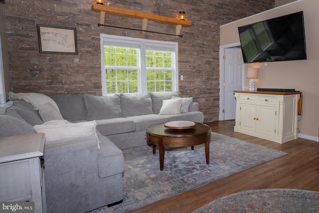 living room featuring baseboards and dark wood-type flooring