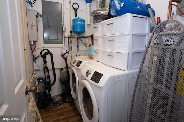 washroom with washer and dryer, electric panel, wood finished floors, and laundry area