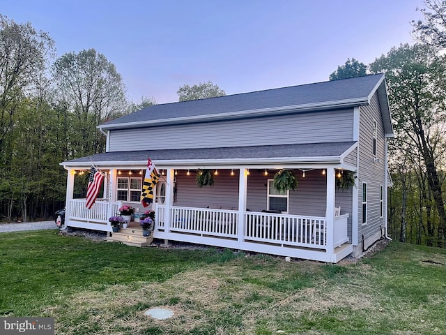 view of front of home with covered porch and a front yard
