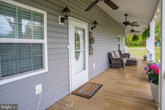 wooden deck with ceiling fan and a porch