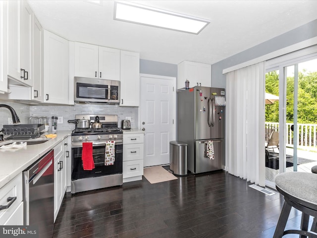 1710 Dennis Ct, District Heights, MD 20747 - kitchen with light countertops, tasteful backsplash, stainless steel appliances, and dark wood-style floors