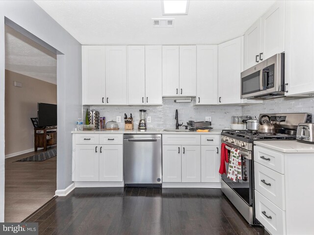 1710 Dennis Ct, District Heights, MD 20747 - kitchen with visible vents, appliances with stainless steel finishes, dark wood finished floors, light countertops, and a sink