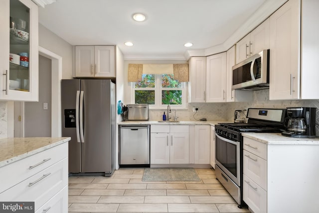 1612 Belvedere Blvd, Silver Spring, MD 20902 - kitchen featuring stainless steel appliances, a sink, backsplash, white cabinetry, and recessed lighting