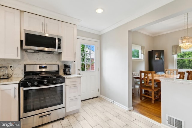 1612 Belvedere Blvd, Silver Spring, MD 20902 - kitchen featuring stainless steel appliances, ornamental molding, decorative backsplash, plenty of natural light, and white cabinetry