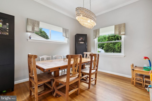 1612 Belvedere Blvd, Silver Spring, MD 20902 - dining area with plenty of natural light, a chandelier, light wood-style flooring, baseboards, and crown molding