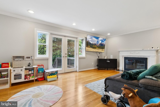 1612 Belvedere Blvd, Silver Spring, MD 20902 - living area featuring ornamental molding, french doors, plenty of natural light, a glass covered fireplace, and wood finished floors