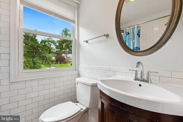 1612 Belvedere Blvd, Silver Spring, MD 20902 - full bath featuring tile walls, plenty of natural light, toilet, vanity, and a wainscoted wall