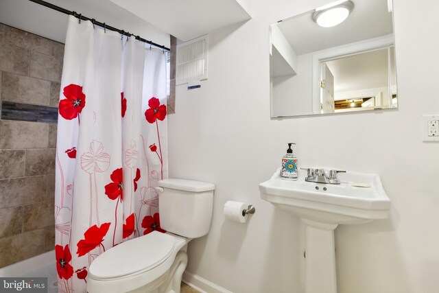 1612 Belvedere Blvd, Silver Spring, MD 20902 - bathroom with toilet, baseboards, shower / bath combo with shower curtain, and a sink
