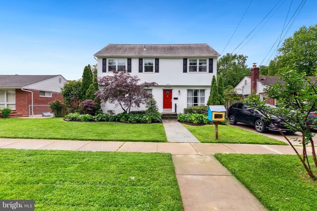 1612 Belvedere Blvd, Silver Spring, MD 20902 - colonial inspired home with a front yard and stucco siding