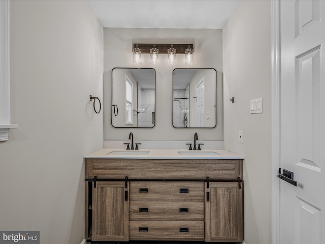 full bathroom with double vanity and a sink