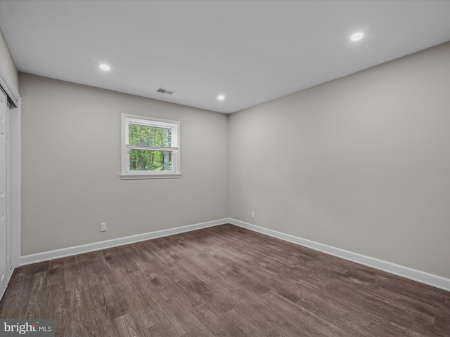 unfurnished bedroom featuring visible vents, a closet, wood finished floors, baseboards, and recessed lighting