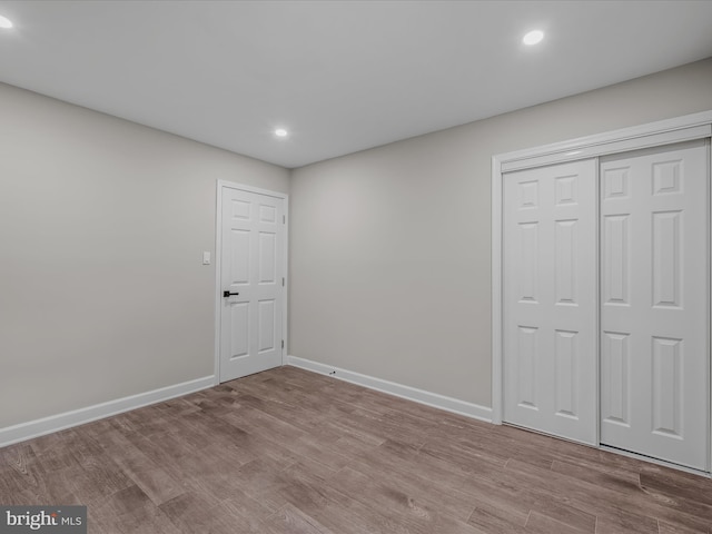 interior space featuring recessed lighting, baseboards, and wood finished floors