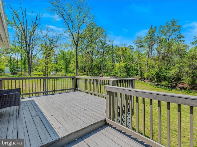 wooden deck with a lawn