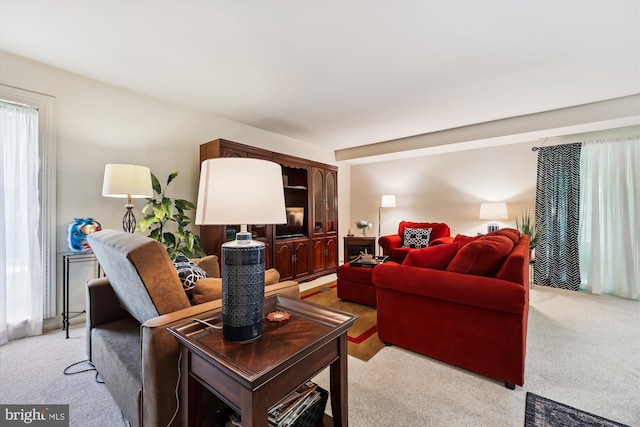 living area featuring light carpet