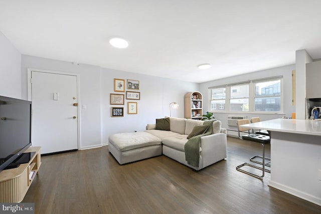living room with baseboards and dark wood finished floors