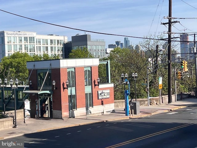 exterior space featuring sidewalks, traffic lights, and curbs