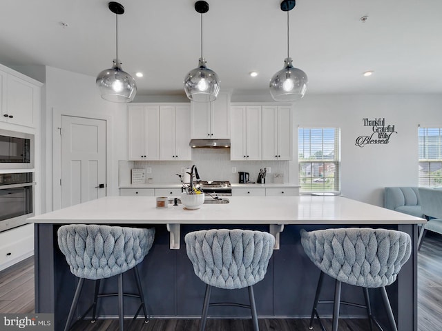 9929 Pesade Way, Upper Marlboro, MD 20772 - kitchen featuring stainless steel oven, under cabinet range hood, healthy amount of natural light, built in microwave, and recessed lighting