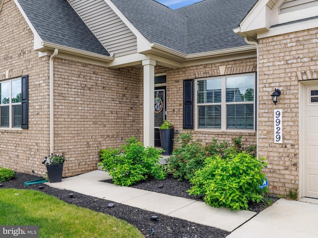 9929 Pesade Way, Upper Marlboro, MD 20772 - doorway to property featuring a shingled roof, brick siding, and a garage